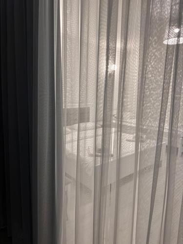 a view of a bed through a window at Spa Hotel Alpin in Solotvyno