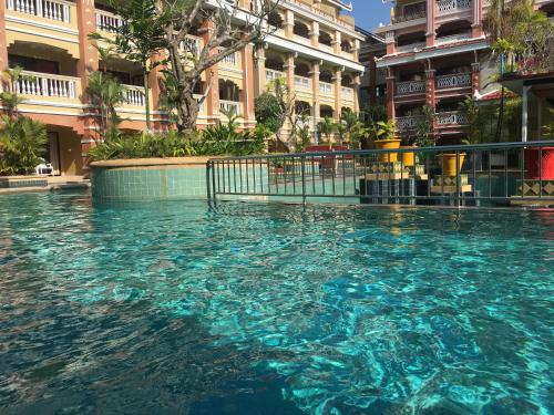 a swimming pool in the middle of a building at Le Ayodhaya Palace Krabi Beach Resort in Krabi town