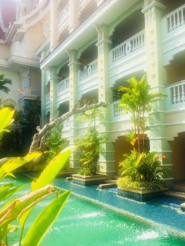 a hotel with a pool in front of a building at Le Ayodhaya Palace Krabi Beach Resort in Krabi town