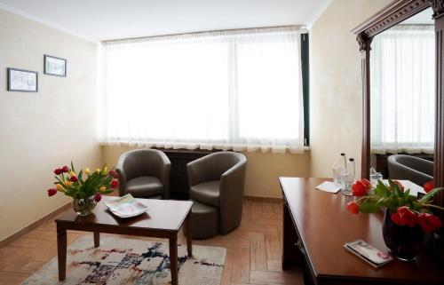 a waiting room with chairs and a table at Central West Hotel in Sofia