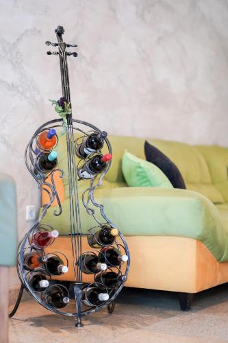 a rack of wine bottles in front of a couch at Central West Hotel in Sofia