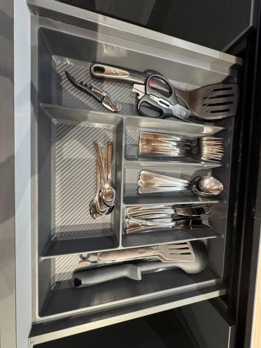 a drawer full of utensils in a refrigerator at Апартаменти на Площі Ринок in Lviv