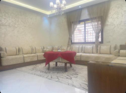 a living room with a couch and a table at Appartement-suite- de standing 10 min de la plage in Agadir