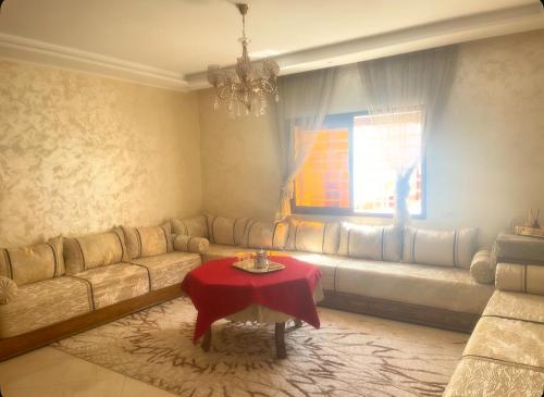 a living room with a couch and a table at Appartement-suite- de standing 10 min de la plage in Agadir
