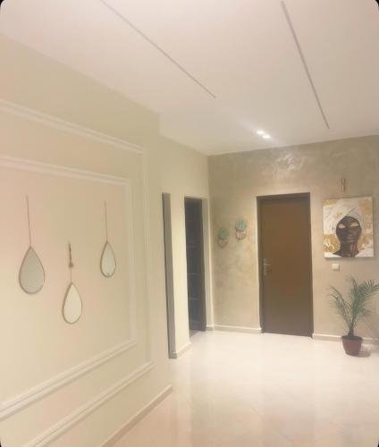 an empty room with a door and a plant at Appartement-suite- de standing 10 min de la plage in Agadir