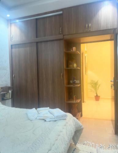 a bedroom with a bed with two towels on it at Appartement-suite- de standing 10 min de la plage in Agadir