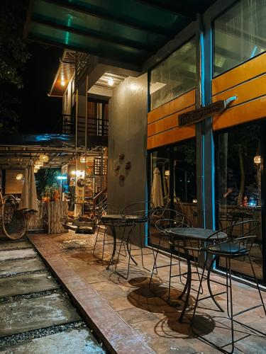 a group of chairs and tables outside of a building at The River House - Govantes Guesthouse in Vigan