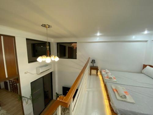 a small room with a bed and a staircase at The River House - Govantes Guesthouse in Vigan