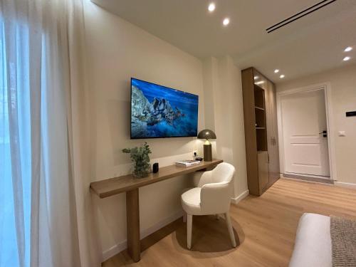 a room with a desk and a white chair at Luxury White Tower Suites in Thessaloniki