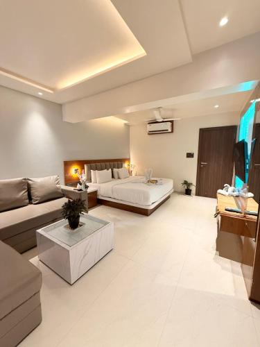 a living room with a bed and a couch at Hotel Emersion Residency in Jāmb
