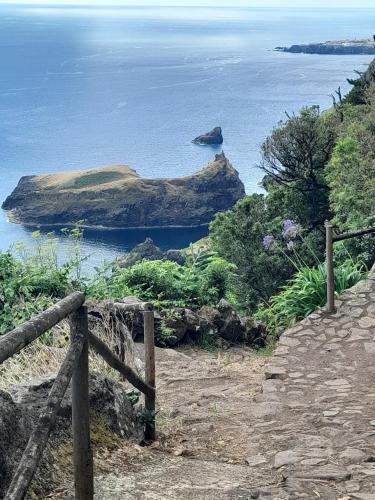 a view of the ocean from a hill with a fence at Casa vicente in Santa Cruz das Flores