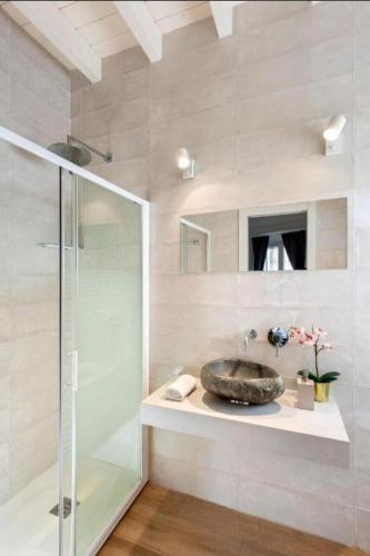 a bathroom with a sink and a glass shower at Bajo Gerona in Seville