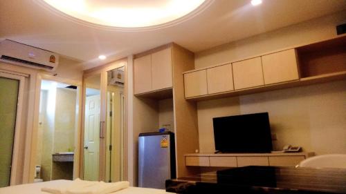 a room with a room with a tv and a room with at B-your home Hotel Don Mueang Airport Bangkok 如你家酒店 in Bangkok