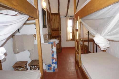 a room with two bunk beds and a sink at Keur Marrakis in Mbour