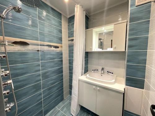a bathroom with a sink and a shower at 2BR Garden Bay Apartment in Varna City