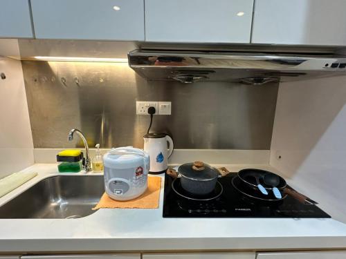 a kitchen with a sink and a stove top oven at Joyful Seaview Studio 118 Island88 for 3pax in George Town