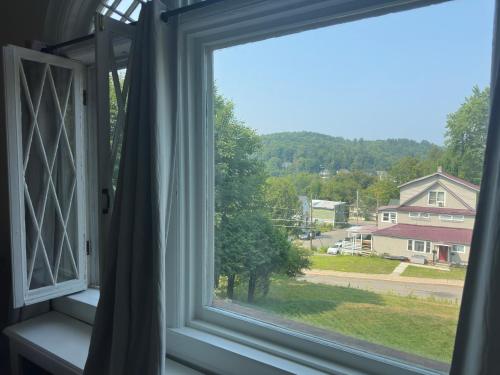 a window with a view of a yard at Franklin Manor Bed and Breakfast in Saranac Lake