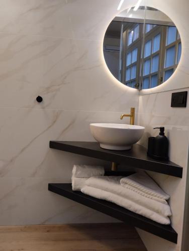 a bathroom with a sink and a mirror at La silla de San Bernardo in Avilés