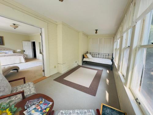 a living room with a bed and a couch at Franklin Manor Bed and Breakfast in Saranac Lake