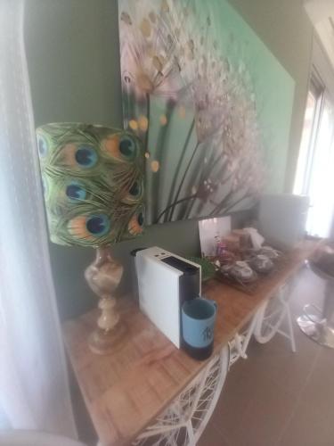 a table with a mirror and a clock on it at La Casa Del Sol Villa Aegina in Aegenitissa