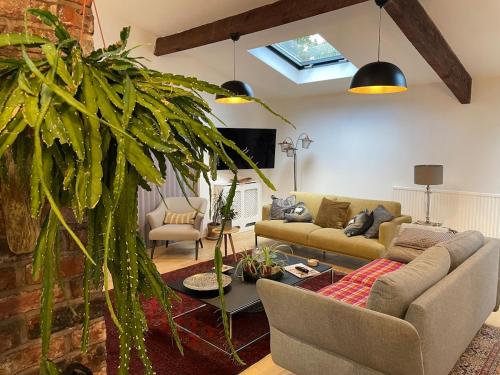 a living room with a couch and a table at Private Luxury Open-Plan Barn Conversion in Sale