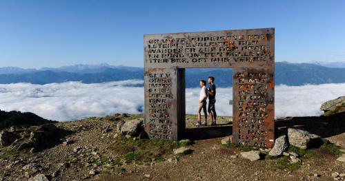 a man and a woman standing on top of a monument on a mountain at 3Traumhaftes Ferienhaus in bester Lage in Döbriach