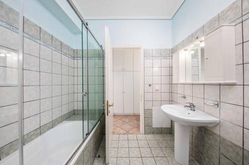 a bathroom with a shower and a sink and a tub at Villa Milka in Kalami