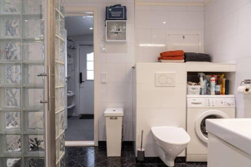 a white bathroom with a toilet and a washing machine at Söromsjön, Funäsdalen in Funäsdalen