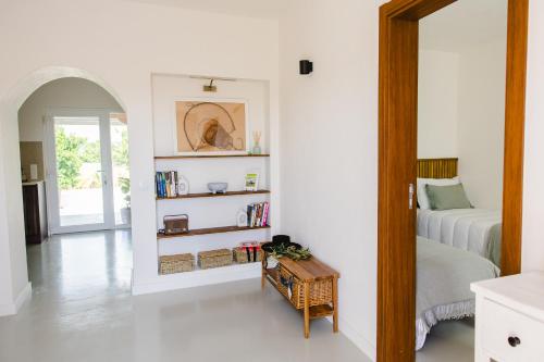 a bedroom with a bed and a table in a room at Casa Maria Avieira in Azinhaga