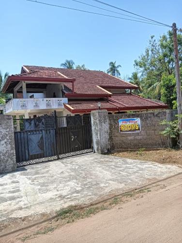 a house with a gate in front of it at Villa village guest house in Trincomalee