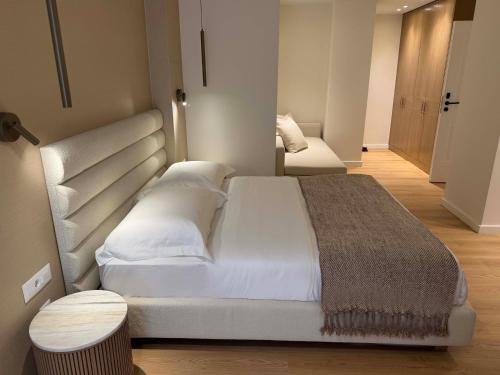 a bedroom with a large white bed in a room at Luxury White Tower Suites in Thessaloniki