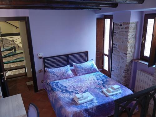 a bedroom with a bed with two towels on it at Residenza Sant'Andrea in Campobasso