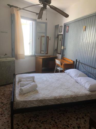 a bedroom with a bed with two towels on it at Old Town Room 2 in Rethymno Town