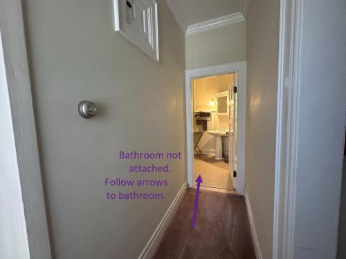 a hallway with a wall with a sign on it at Franklin Manor Bed and Breakfast in Saranac Lake