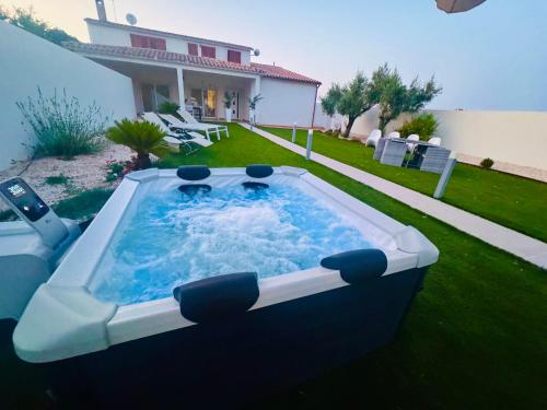 a large hot tub in the yard of a house at Casa MILLY in Olbia