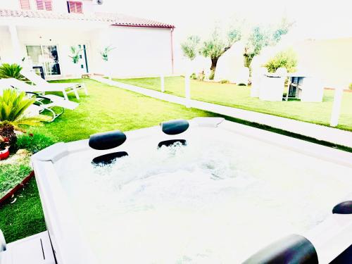 a hot tub in the backyard of a house at Casa MILLY in Olbia