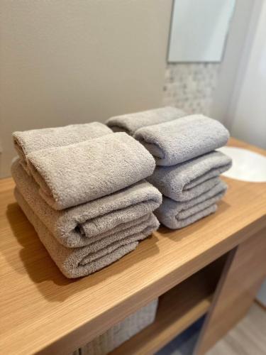a pile of towels sitting on a counter in a bathroom at Le Repos軽井沢 in Karuizawa