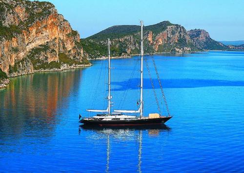 a boat sitting in the middle of a large body of water at Navarone Villas in Petrokhorion