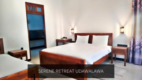 a bedroom with a bed and two night stands at Serene Retreat Udawalawa in Udawalawe