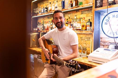 a man is playing a guitar in a bar at Abbey Court Hostel in Dublin