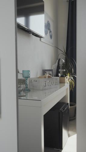 a kitchen with a white counter with a sink at Mhometredici Guest House in Sestu