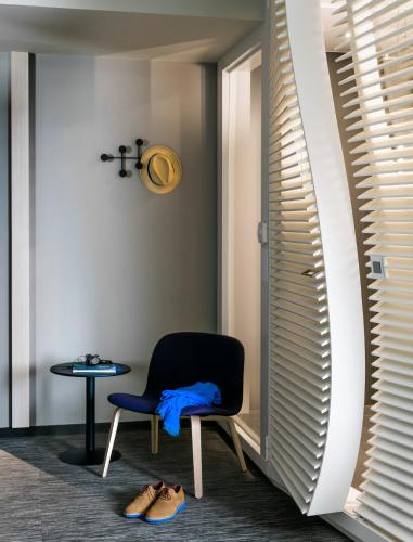 a room with a chair and a table at OKKO Hotels Bayonne Centre in Bayonne