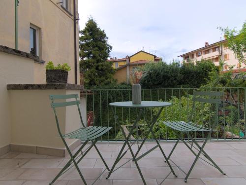 two chairs and a table with a vase on it at Lario Nest - The Suites in Mandello del Lario