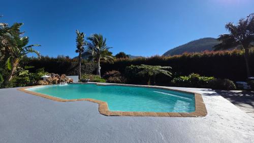 a swimming pool in the middle of a yard at Pet-Friendly Courtyard Suite Tsitsikamma Gardens in Sanddrif