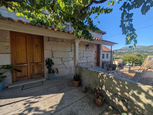 a house with a wooden door and a balcony at Apartamentos Turísticos Casa Roque in Gondomar