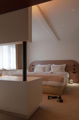 a bedroom with a bed and a large window at MiHotel - Rue Cuvier in Lyon