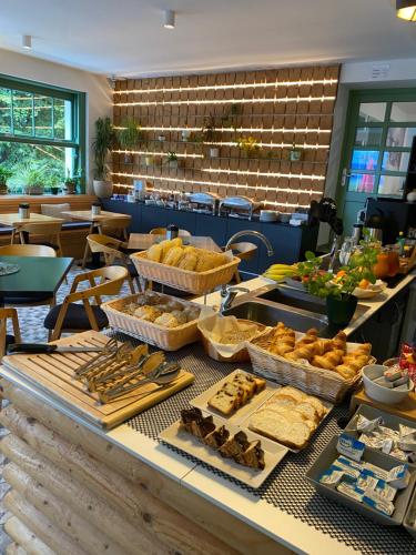 a buffet with bread and other food on a table at Pension Jitřenka Hřensko - Breakfast Included & Free Parking in Hřensko