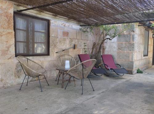 a group of chairs and a table on a patio at Agroturismo Finca Sant Blai in Campos