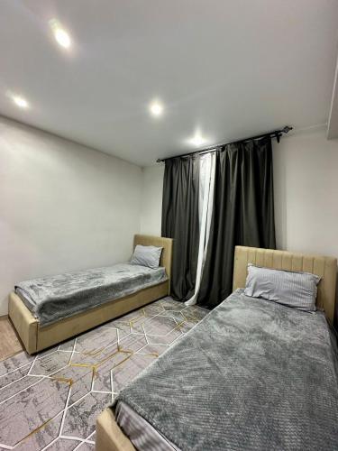 a room with two beds and a window at Kolsay Lakes in Saty