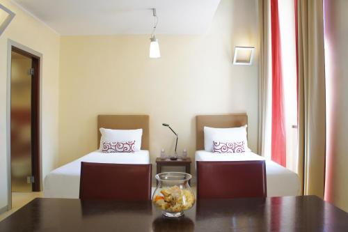 Ένα ή περισσότερα κρεβάτια σε δωμάτιο στο La Griffe Hotel Roma